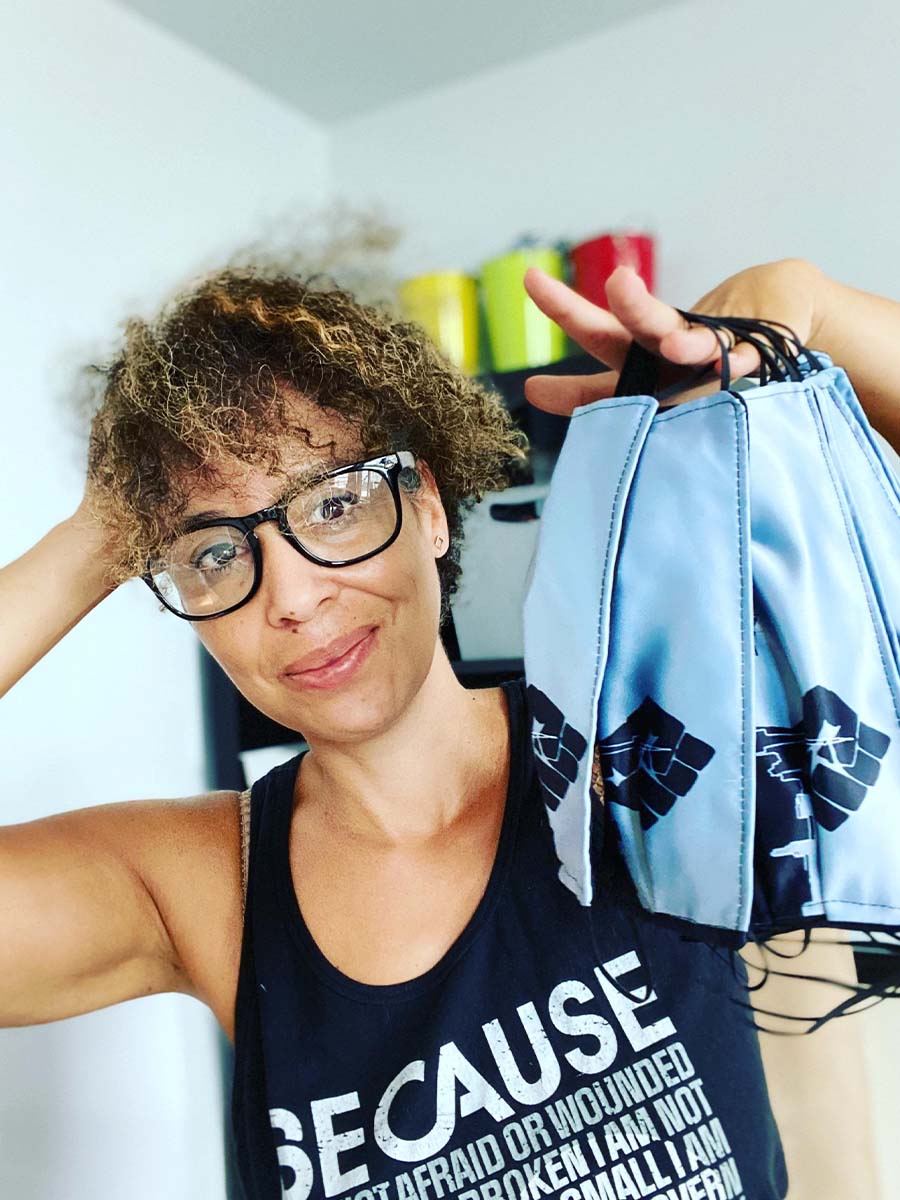 Nadia Lloyd holding up her Black Lives Matter face masks 